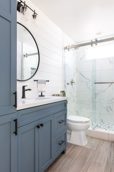 White bathroom with nautical blue cabinets