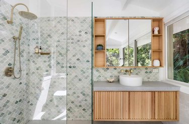A bathroom with tropical themed tile.