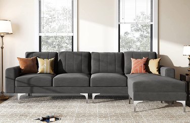 gray sectional in velvet with stitching