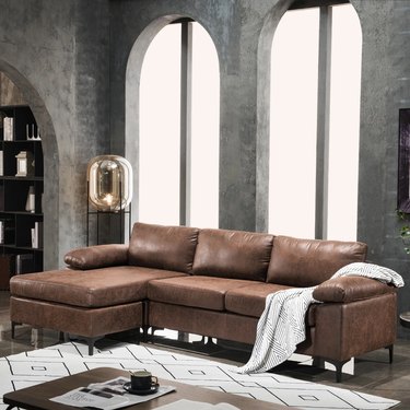 dark faux leather sectional in modern room