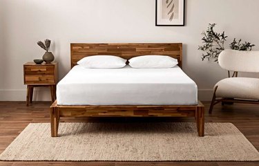Silk & Snow Wooden Bed Frame with white sheets and pillows.