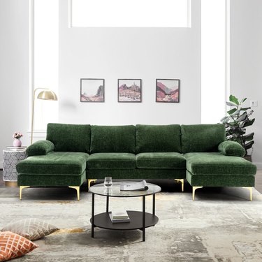 u-shaped green sofa in simple, neutral living room