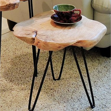 Natural wood and metal legged end table.