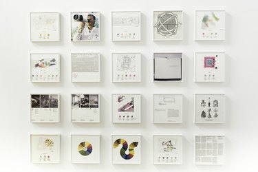 A collection of white framed pictures, maps, and graphs as part of the "Olfactory Futures" exhibition at the Istanbul Museum of Art's 2012 Design Biennial.