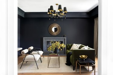 black living room idea with emerald green sofa