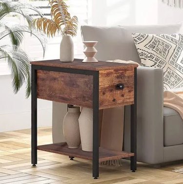 Wood and metal end table with drawer and lower shelf.