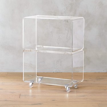 A small clear shelving unit on wheels