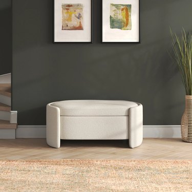 boucle storage bench on green wall