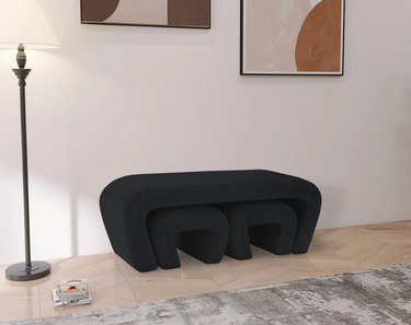 black boucle bench with smaller stools beneath