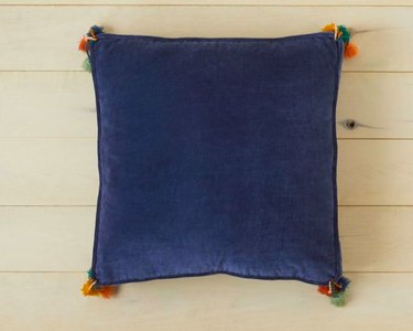 blue floor pillow with tassels