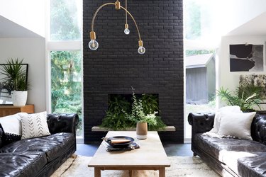 black living room with painted brick wall