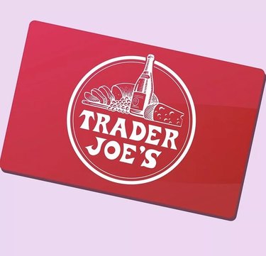 Trader Joe's red gift card with the logo on a pale pink background.