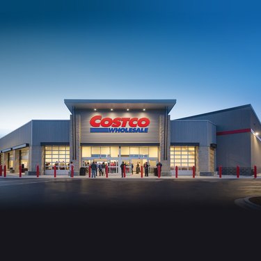 The exterior of a Costco Wholesale warehouse at twilight.
