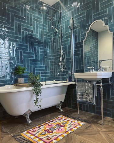 Bathroom with blue herringbone wall tiles