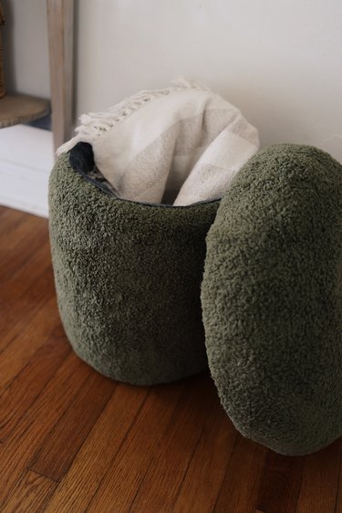 Green sherpa mushroom stool with lid off and blanket inside
