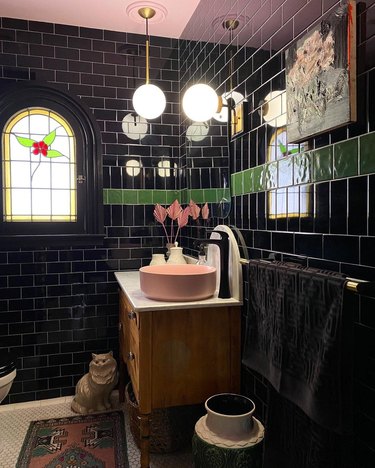 Opulent black bathroom with a stained glass window