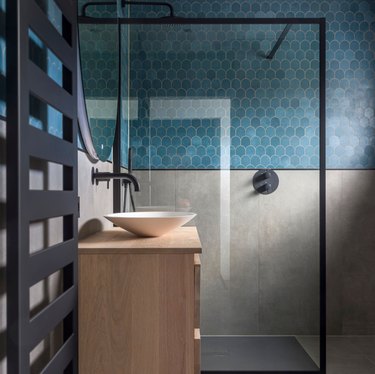 industrial bathroom with blue scalloped tiles