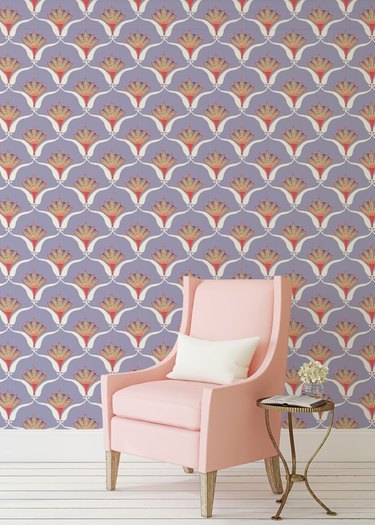pink chair with side table and vibrant lilac wallpaper in the background