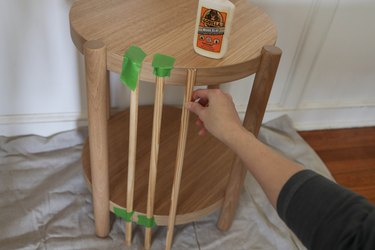 Gluing fluted wood pieces to table with wood glue