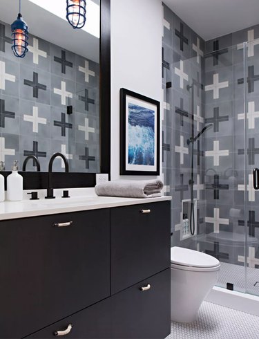small industrial bathroom with plus-sign patterned wall tile