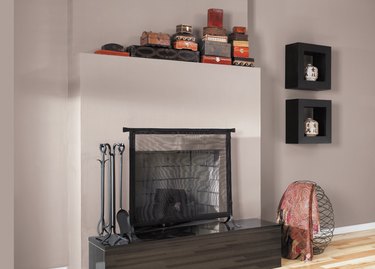 fireplace area with decor and black shelves nearby