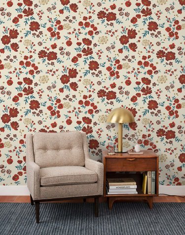 seating area with side table and floral wallpaper