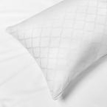 white pillow over the bed
