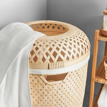 bamboo laundry basket with towel inside