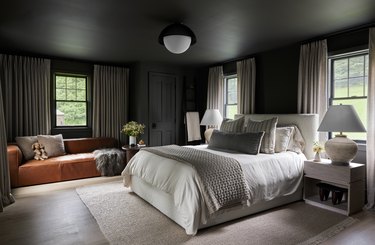 bedroom with dark walls and light bed