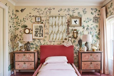 Little girl's bedroom with hot pink headboard, mural wallpaper, bird art collage, and pale pink curtains