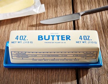 west elm butter dish with stick of butter on it