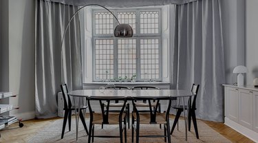 Dining room with arch floor lamp.