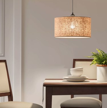 Pendant lamp with beige linen shade.