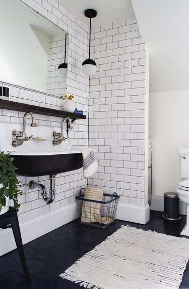 black and white industrial bathroom with trough sink
