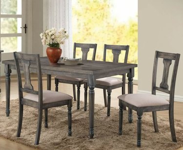 Farmhouse dining table and chairs with spindle legs.