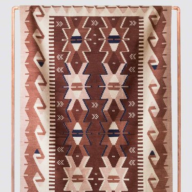 patterned rug with navy, dark red, camel, and tan