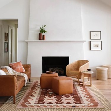patterned rug layered on jute rug in living room