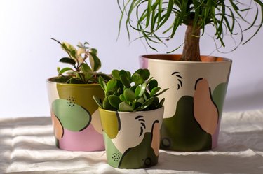 three pots in various colors
