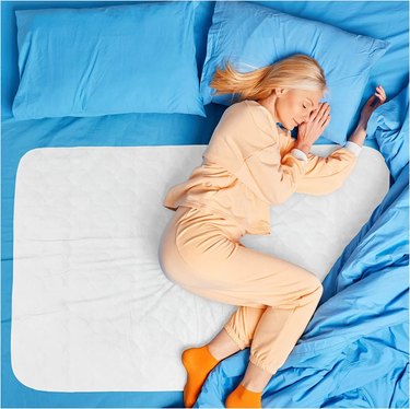 woman sleeping on mattress pad