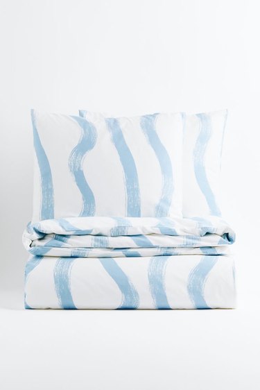 Folded white duvet set with blue stripes