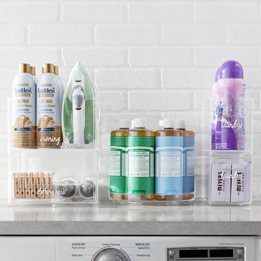 laundry supplies in clear bins