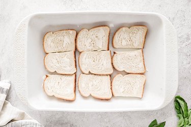 Buttered bread slices in a casserole dish