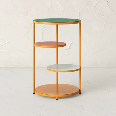 outdoor tiered plant stand with various in colored shelves