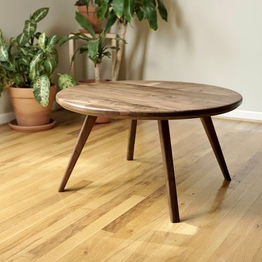 round table on hardwood floor near plants