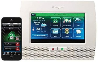 A Honeywell alarm system with a mobile phone paired with an app