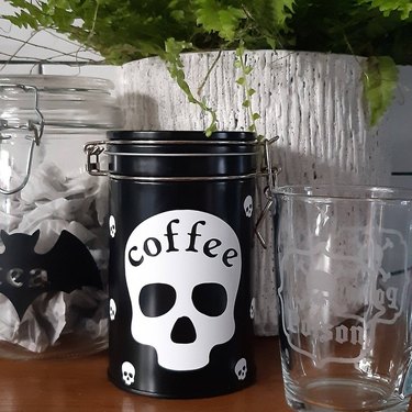 black storage container with white skull label reading "coffee"