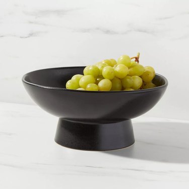 black fruit bowl with grapes