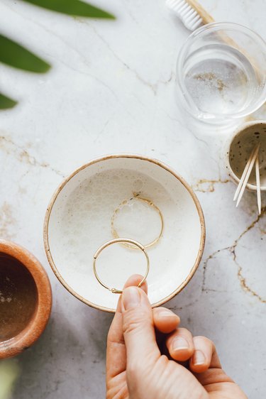 Soak gold jewelry in water and gentle soap