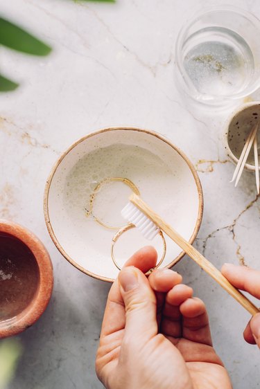 Scrub jewelry with a soft toothbrush