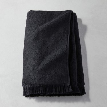 black bath towel with fringed end